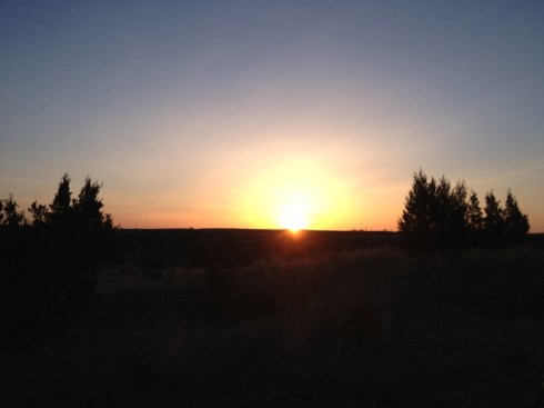 Just as the sun dips down and sets in the west behind the badlands buttes.