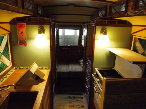 An interior shot of the sweet circus ride. Note the stove range to the right; sink to the lower left; toilet further back; and bed at the way back.