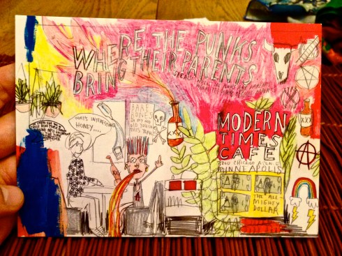 A Modern Times Cafe postcard indicating that this is a place where punks bring their parents. 