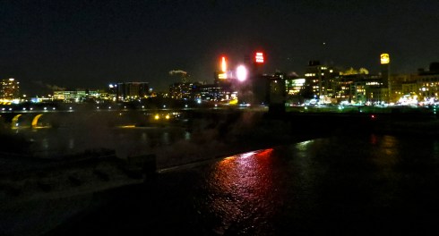 The Mississippi River reflects the neon Gold Medal Flour signage (among other signs). Photo taken from the Central Avenue NE bridge, view to the south.